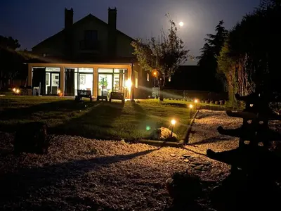 a house with lights in the yard at night at Loft anexo en chalet, con piscina de uso privado in San Juan