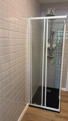 a shower with a glass door in a bathroom at Loft anexo en chalet, con piscina de uso privado in San Juan