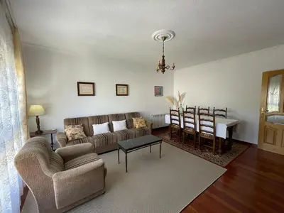 a living room with a couch and a table at Acogedor piso en Sarria in Sarria