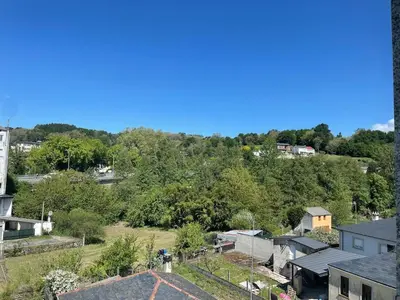 an aerial view of a town with trees and buildings at Acogedor piso en Sarria in Sarria