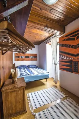 a bedroom with a bed and a wooden ceiling at Casa rural en Playa de Frejulfe in Frejulfe