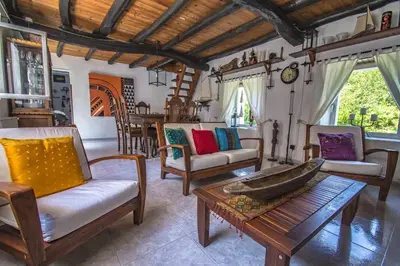 a living room with chairs and a table at Casa rural en Playa de Frejulfe in Frejulfe