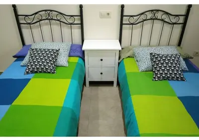 a bedroom with two beds and a night stand at Gatonegro in Trefacio