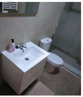 a bathroom with a white sink and a toilet at Gatonegro in Trefacio
