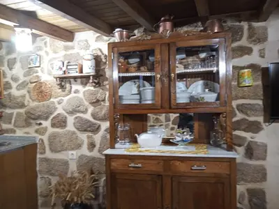 a kitchen with a wooden cabinet with dishes in it at A Florentina in Rubiacós