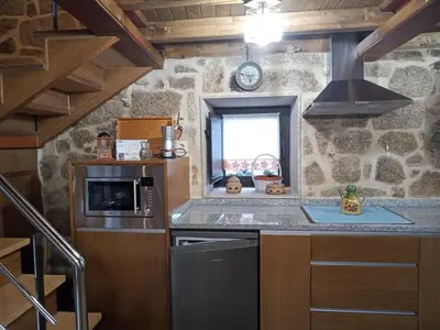 a kitchen with a stove and a sink in a room at A Florentina in Rubiacós