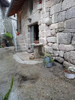 a stone building with a stone bench next to a window at A Florentina in Rubiacós