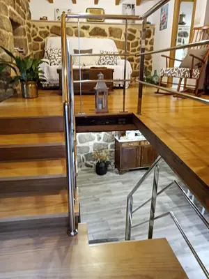 a living room with a bed and a wooden floor at A Florentina in Rubiacós