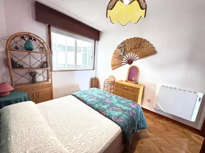 a bedroom with a bed and a window at Apartamento Parquemar Viveiro in Viveiro