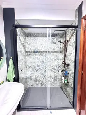a shower with a glass door in a bathroom at Apartamento Parquemar Viveiro in Viveiro