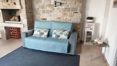a blue chair with two pillows in a living room at Casa de Invitados con asador y piscina de uso privado in Foz