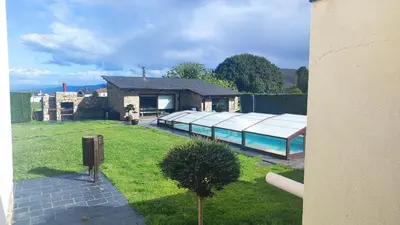 a house with a swimming pool in a yard at Casa de Invitados con asador y piscina de uso privado in Foz