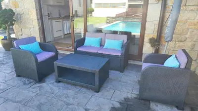 a group of chairs and a table and a pool at Casa de Invitados con asador y piscina de uso privado in Foz
