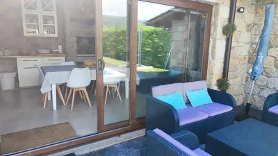 a kitchen and dining room with a table and chairs at Casa de Invitados con asador y piscina de uso privado in Foz