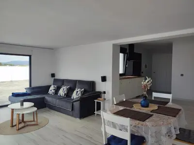 a living room with a couch and a table at O barco de Coto in Barreiros