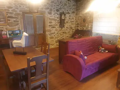 a living room with a couch and a table at Casa Vacacional Familia Ferro in Cartelle