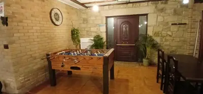 a room with a wooden table in front of a door at Afouteza in Pontevedra
