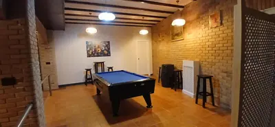 a ping pong table in a room with a brick wall at Afouteza in Pontevedra