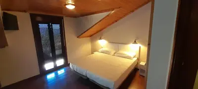 a bedroom with a bed with two pillows and a window at Afouteza in Pontevedra