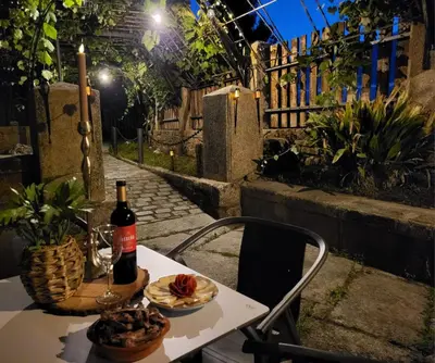 a table with a bottle of wine and a plate of food at Afouteza in Pontevedra