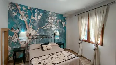 a bedroom with a bed with a painting on the wall at Casas rurales en Sanabria in Coso