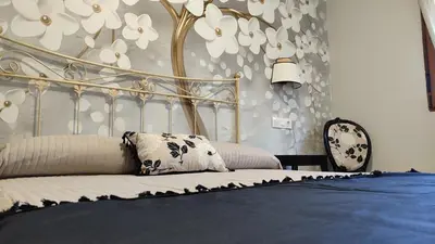 a bedroom with a bed with a blue comforter at Casas rurales en Sanabria in Coso