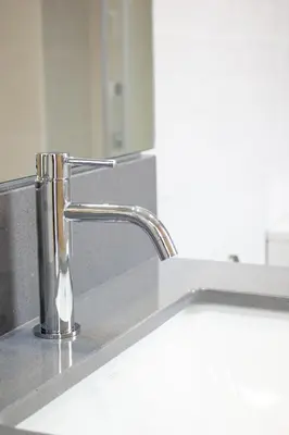 a kitchen sink with a chrome faucet at Pensión da Sela in Santiago de Compostela