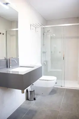 a bathroom with a sink and a toilet and a shower at Pensión da Sela in Santiago de Compostela