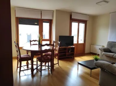 a living room with a table and chairs and a couch at Figueras 3 in figueras