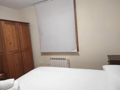a bedroom with a white bed and a window at Figueras 3 in figueras