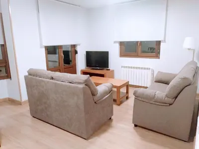 a living room with two chairs and a table at Figueras 4 in figueras