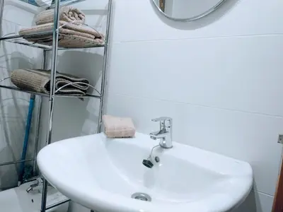 a bathroom with a sink and a mirror and towels at Figueras 4 in figueras