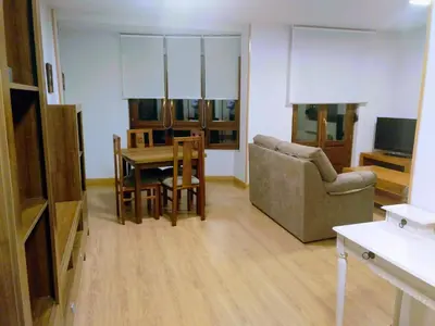 a living room with a table and a couch at Figueras 4 in figueras