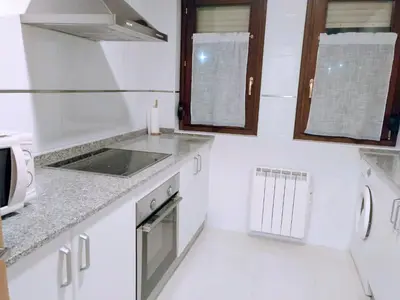 a white kitchen with a sink and a stove at Figueras 4 in figueras