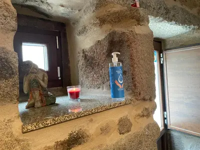 a bottle of water and a glass on a wall at Casa Arteleira in Padrón