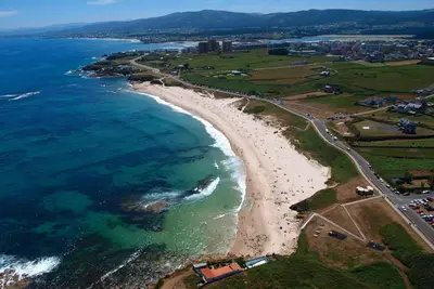 an aerial view of a beach and the ocean at Apartamento centro de Foz con piscina in Foz