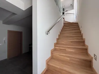 a staircase in a house with wooden floors at Casa Rural O Lar Das Fontiñas in Moreiras