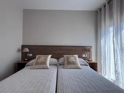 a bedroom with a large bed with two pillows at Casa Rural O Lar Das Fontiñas in Moreiras