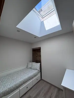 a bedroom with a bed and a skylight at Casa Rural O Lar Das Fontiñas in Moreiras
