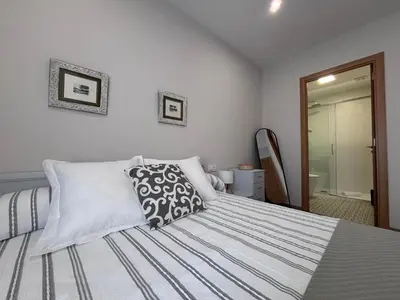 a bedroom with a bed with two pillows on it at Casa Rural O Lar Das Fontiñas in Moreiras