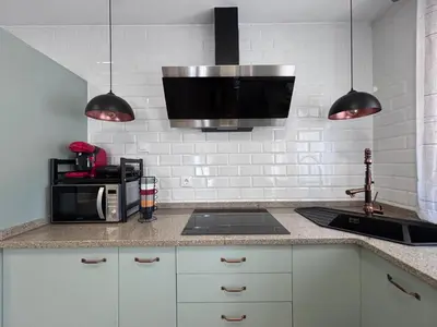 a kitchen with a sink and a microwave at Casa Rural O Lar Das Fontiñas in Moreiras
