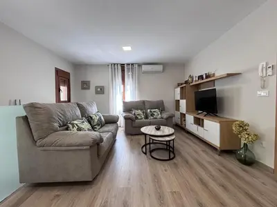 a living room with a couch and a tv at Casa Rural O Lar Das Fontiñas in Moreiras