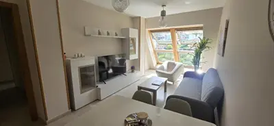 a living room with a couch and a table at Ático Paraíso in San Ciprián