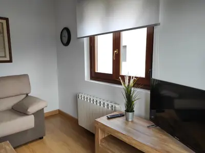 a living room with a couch and a television at Figueras 6 in figueras