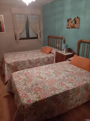 a bedroom with two beds and a table at Medulillas de Yeres in Yeres