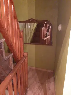 a staircase in a room with wooden stairs and a mirror at Medulillas in Yeres