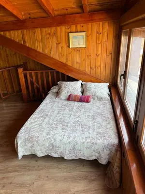 a bedroom with a bed in a wooden cabin at Medulillas in Yeres