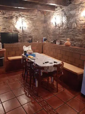 a kitchen with a table and chairs in a room at Medulillas in Yeres