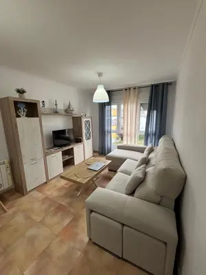 a living room with a couch and a table at Ilusiones Da Mariña in San Ciprián