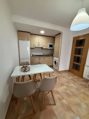 a kitchen with a table and chairs in a room at Ilusiones Da Mariña in San Ciprián